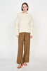 Girl wearing MIRTH women's handknit cortina cable pullover sweater in cream white wool