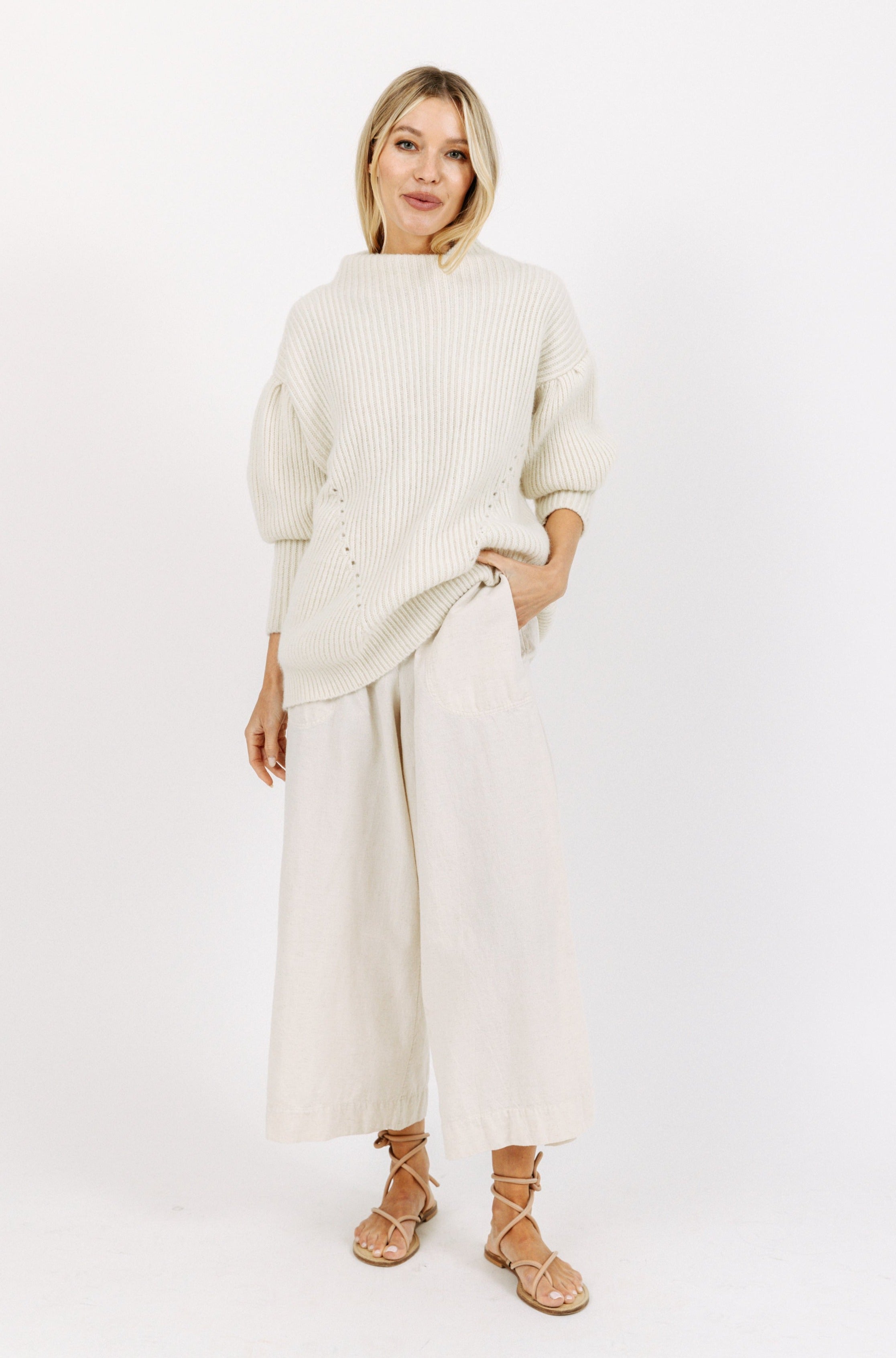 Girl wearing MIRTH women's paperbag waist wide leg palazzo pant in oatmeal beige