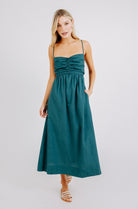 Girl wearing MIRTH women's tie back cutout deia midi sundress in spruce green poplin