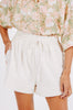 Girl wearing MIRTH women's elastic drawstring woodstock cotton wide leg shorts with pockets in bone cream