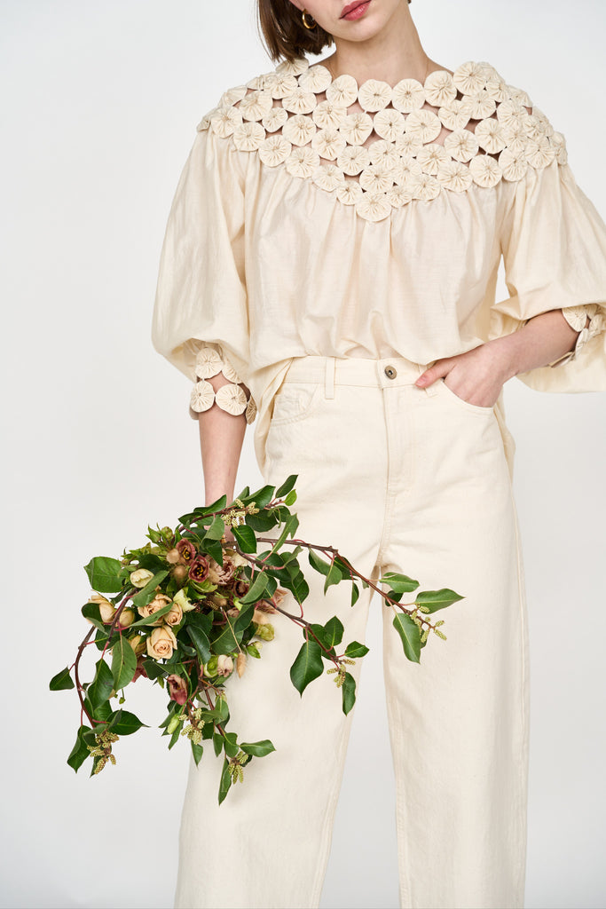 Girl wearing MIRTH women's pullover rosette rosenberg blouse in cream cotton silk