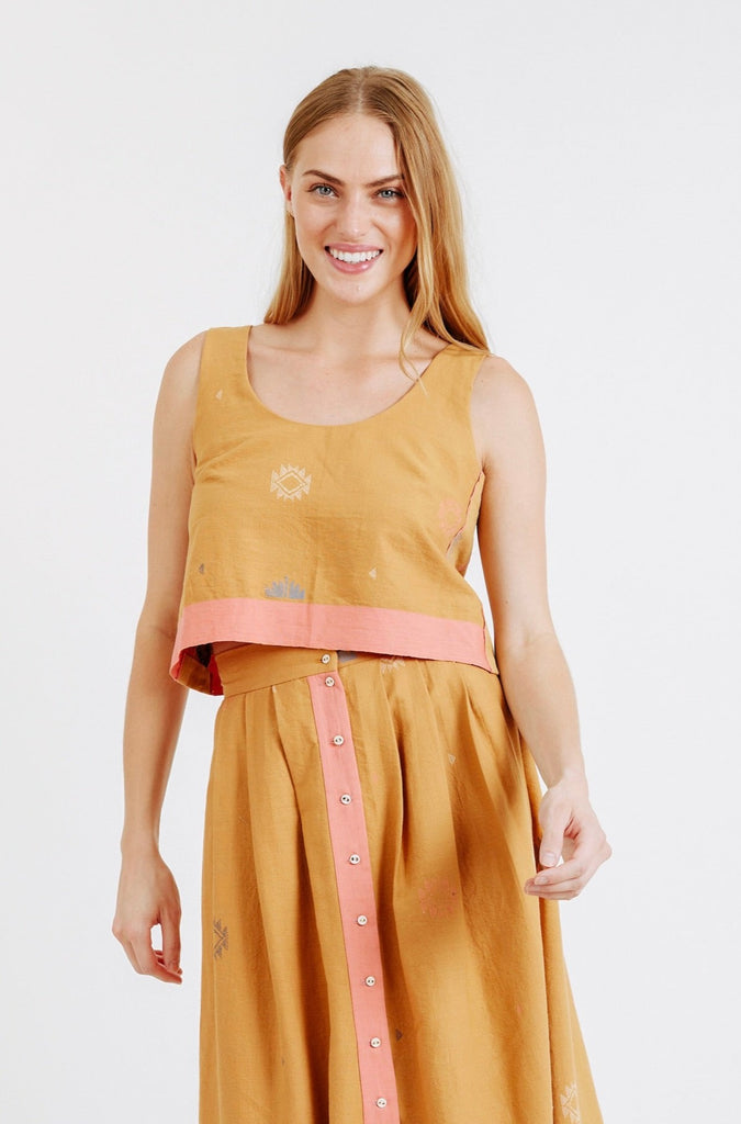 Girl wearing MIRTH women's sleeveless hudson tank top set in handloomed sedona orange jamdani cotton