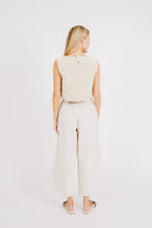 Girl wearing MIRTH women's knit sleeveless tahiti tank top coverup in natural macrame cream