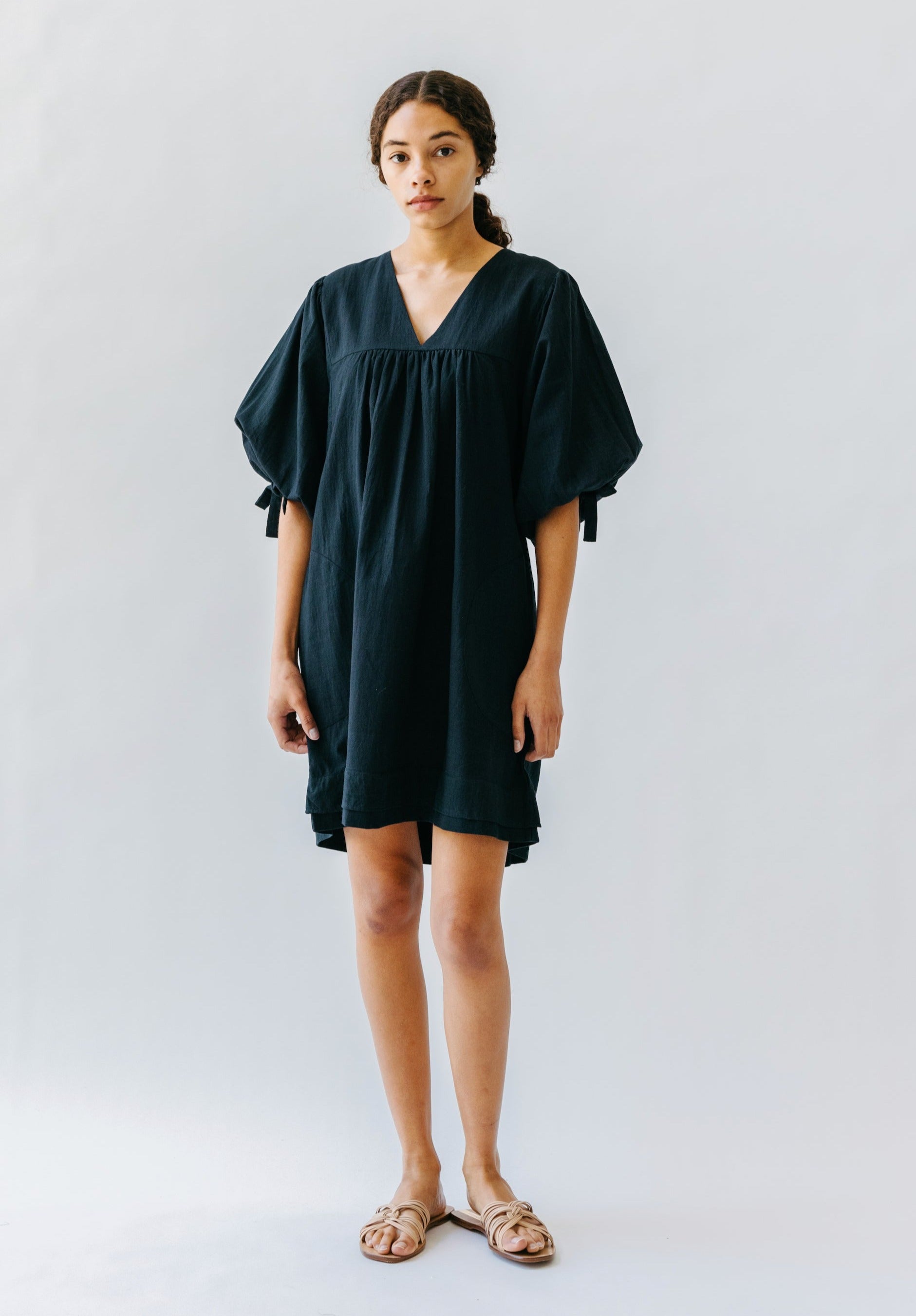 Girl wearing MIRTH women's balloon sleeve short" belem" vacation dress and coverup in black cotton