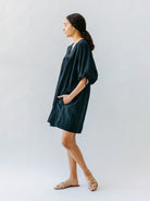 Girl wearing MIRTH women's balloon sleeve short" belem" vacation dress and coverup in black cotton